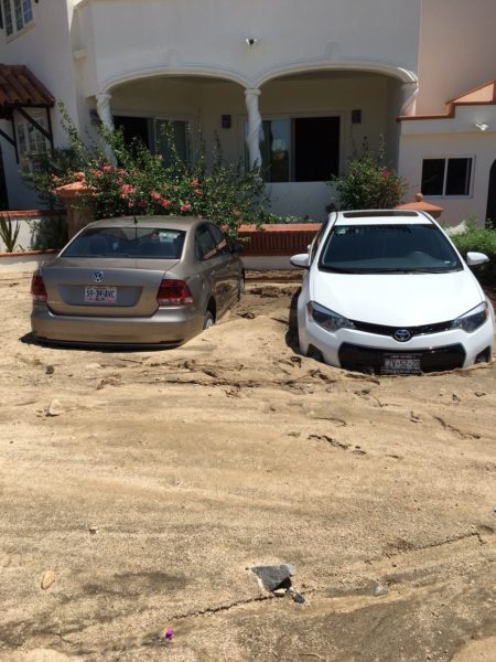 Cars stuck in silt left behind a thunderstorm